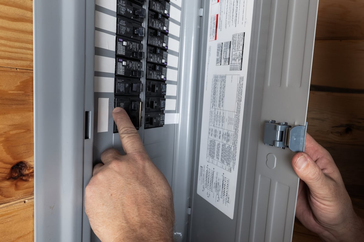 Inspecting a residential electrical breaker panel to diagnose a power problem